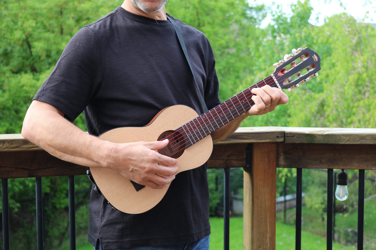The Ventura held in two hands outdoors, showing its compact size against a person's body